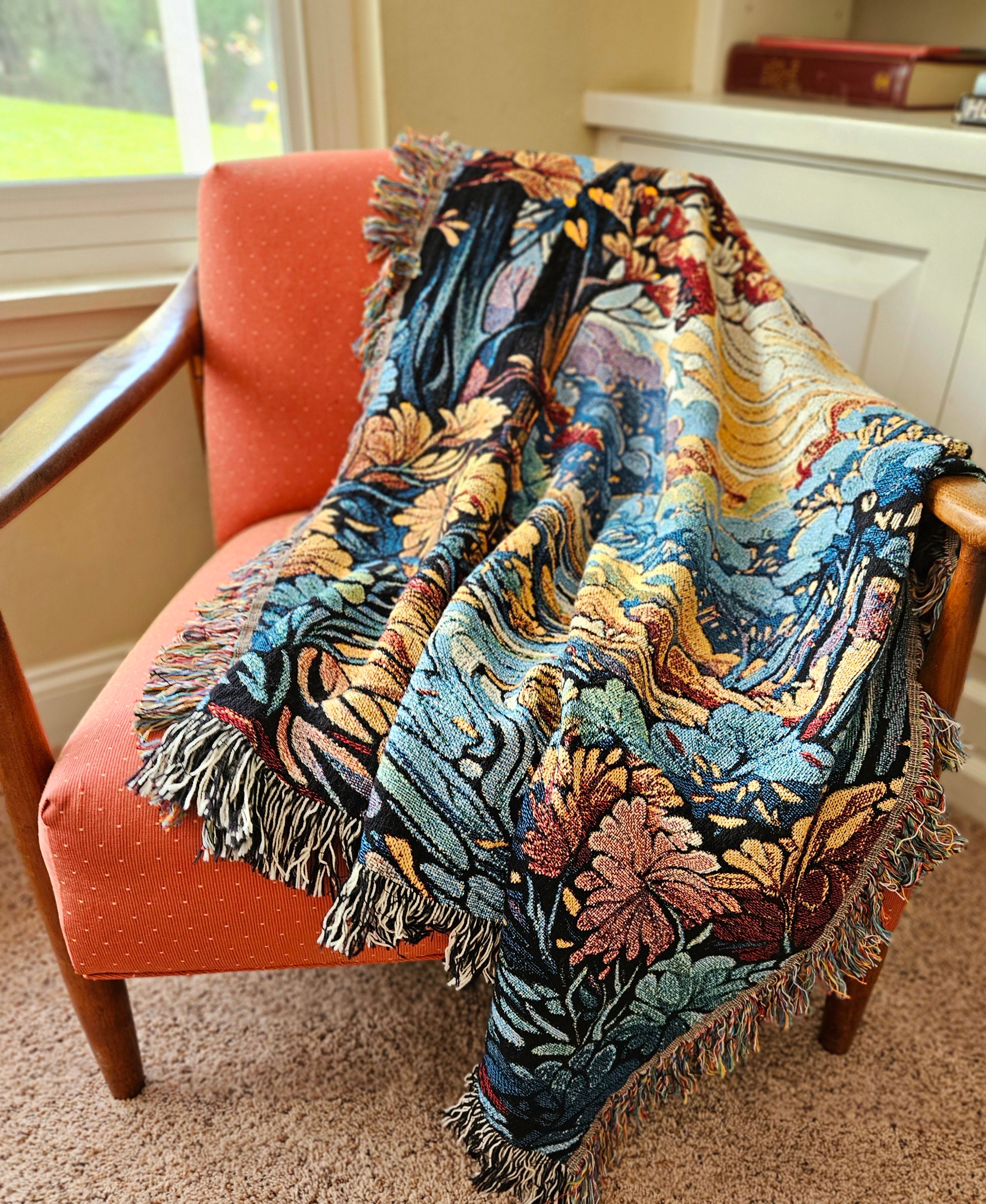 Colorful blanket draped over a chair, showcasing intricate patterns and textures, set indoors near a window, conveying a cozy and inviting atmosphere.