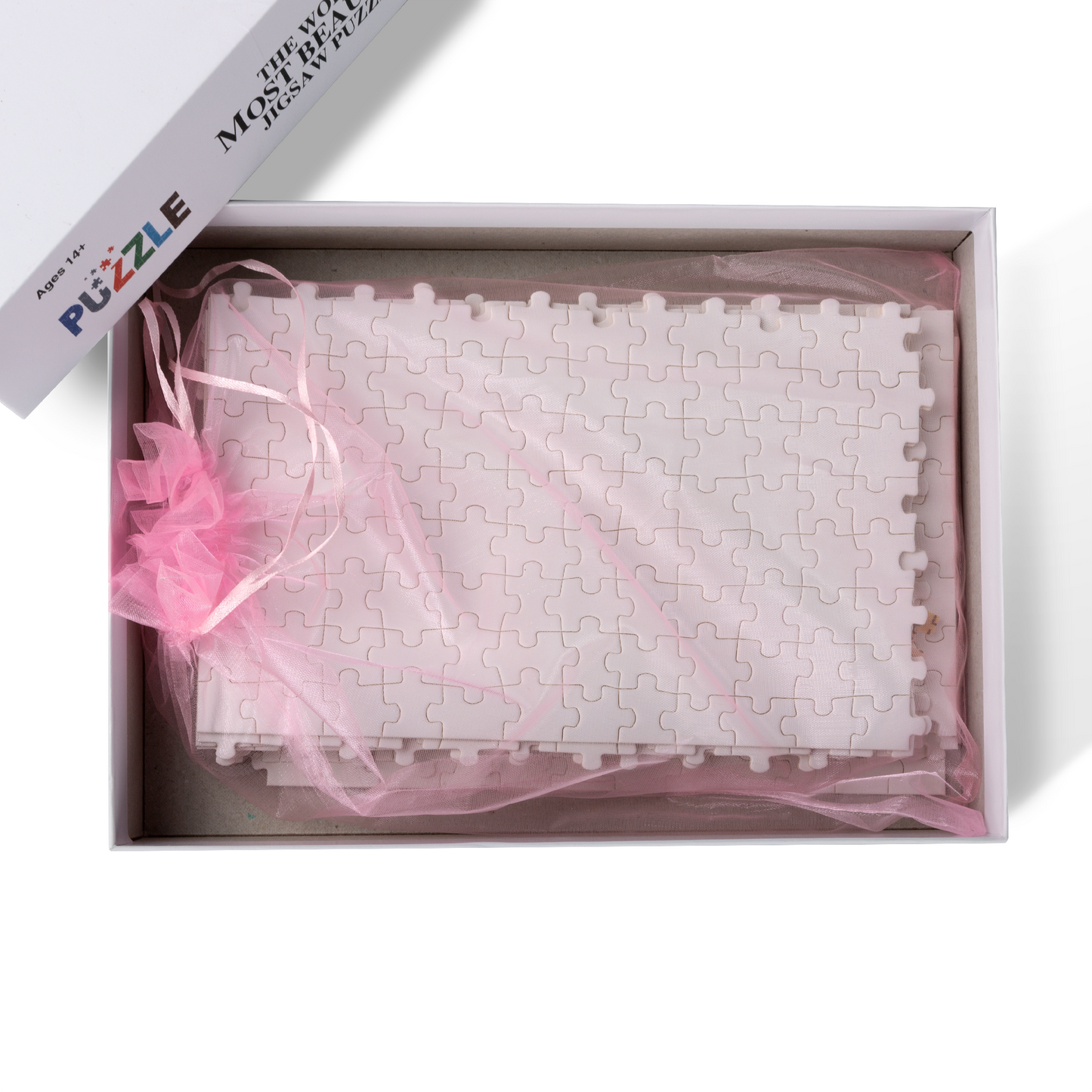 A boxed jigsaw set with a pink bow, available in 500 and 1000 pieces featuring intricate art by Artifact1337