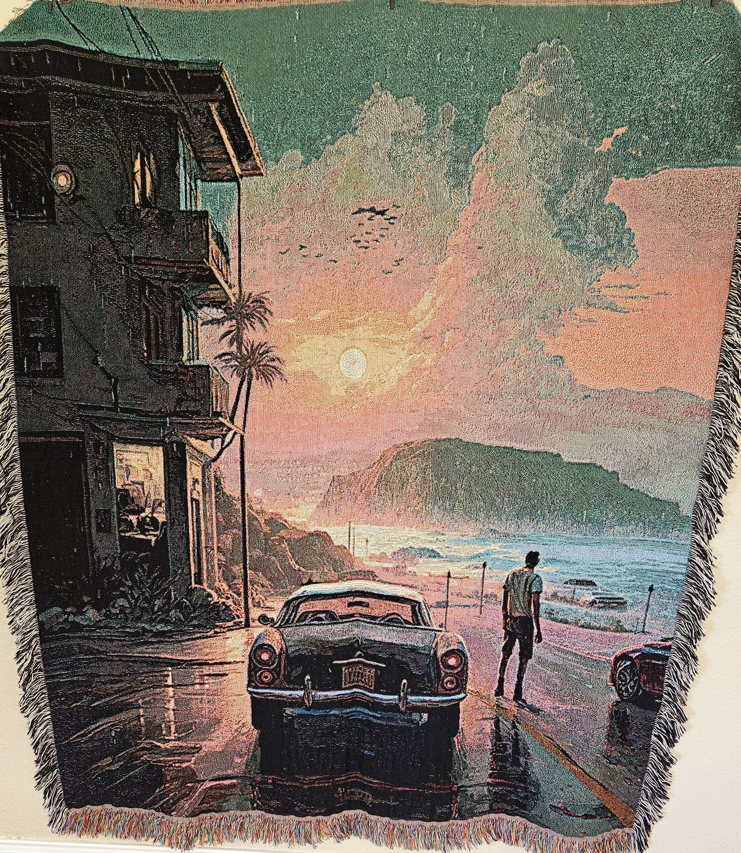 Man walking by a car under rain depicted on the Reflections in the Rain woven blanket from Artifact1337, showcasing luxury and intricate weaving.