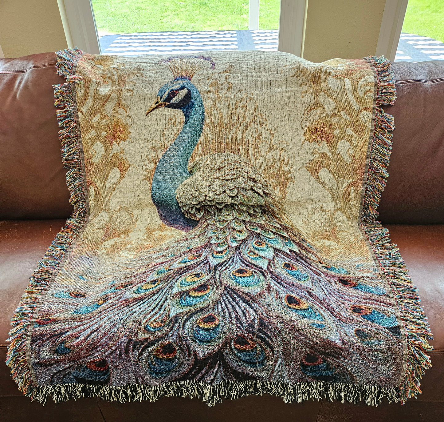 The Peacock Emperor woven blanket showcases a detailed peacock design, highlighting luxurious craftsmanship ideal for enhancing home décor.