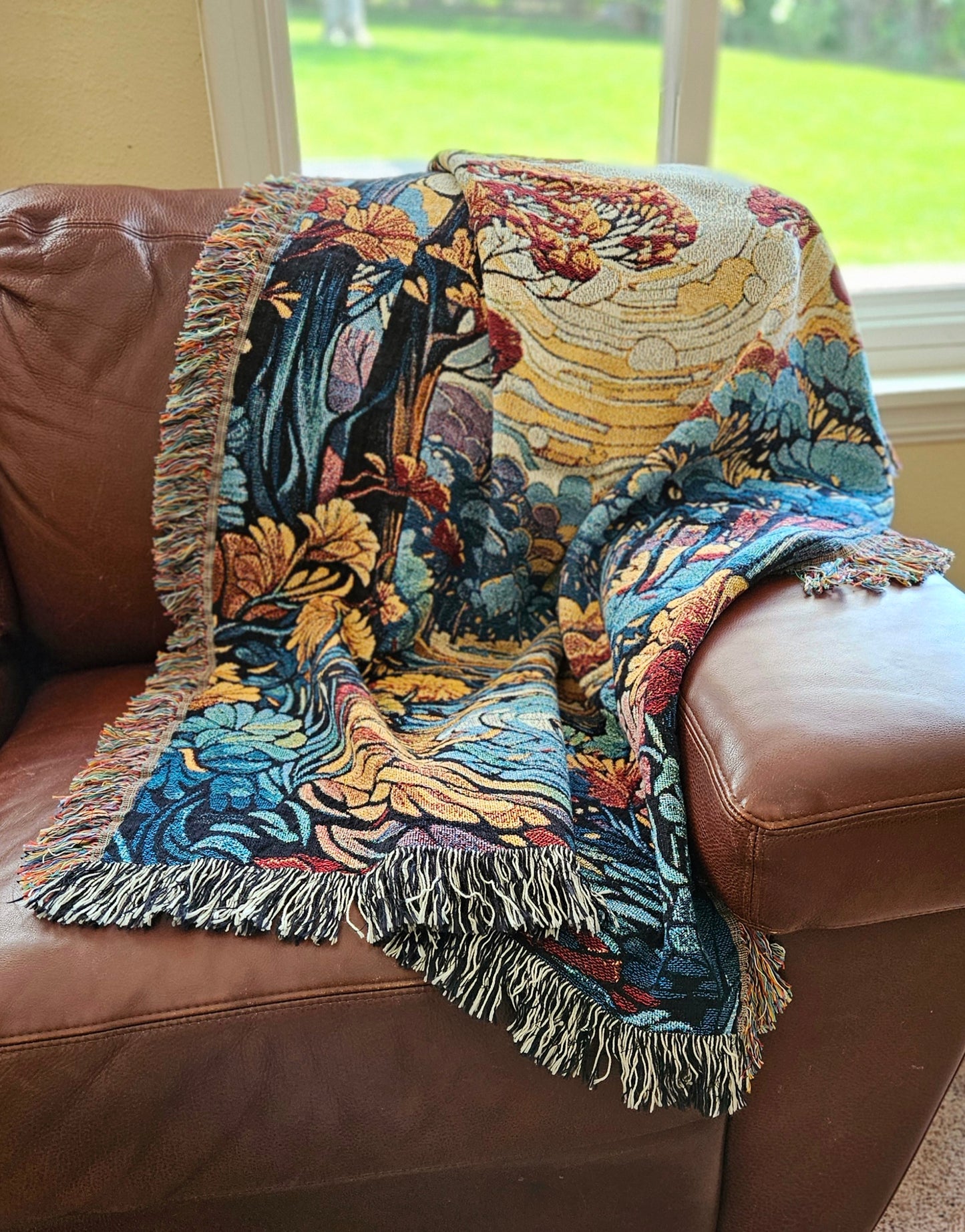 Flowing Serenity Woven Blanket featuring a colorful tapestry of trees and a river, highlighting its luxurious, intricate design.