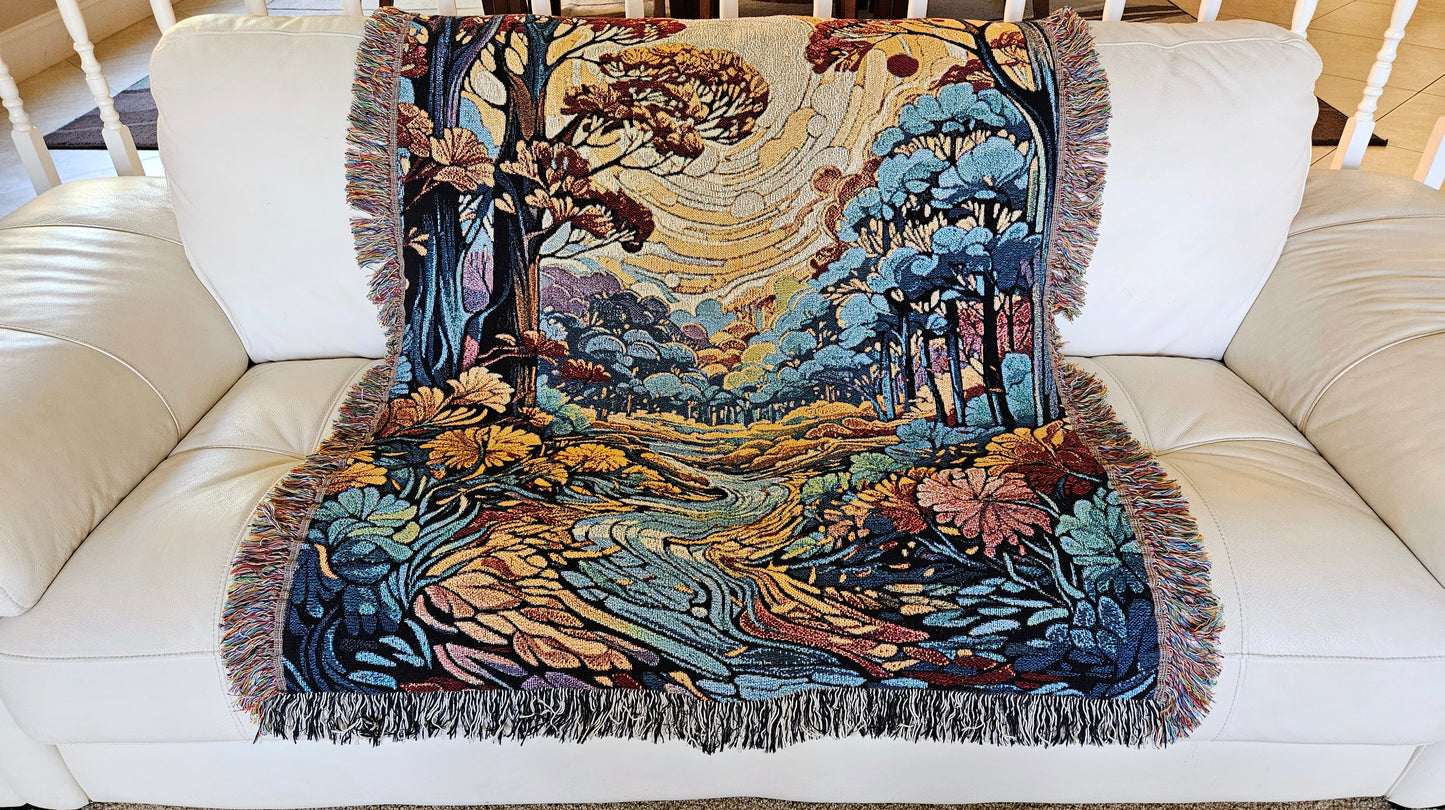 Flowing Serenity Woven Blanket featuring a colorful tapestry of trees and a river, highlighting its luxurious, intricate design.