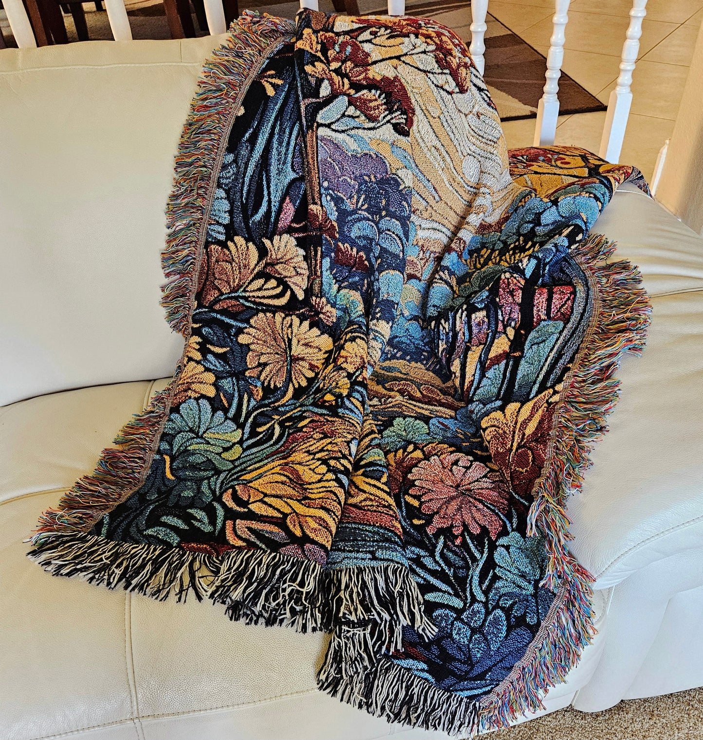 Flowing Serenity Woven Blanket featuring a colorful tapestry of trees and a river, highlighting its luxurious, intricate design.