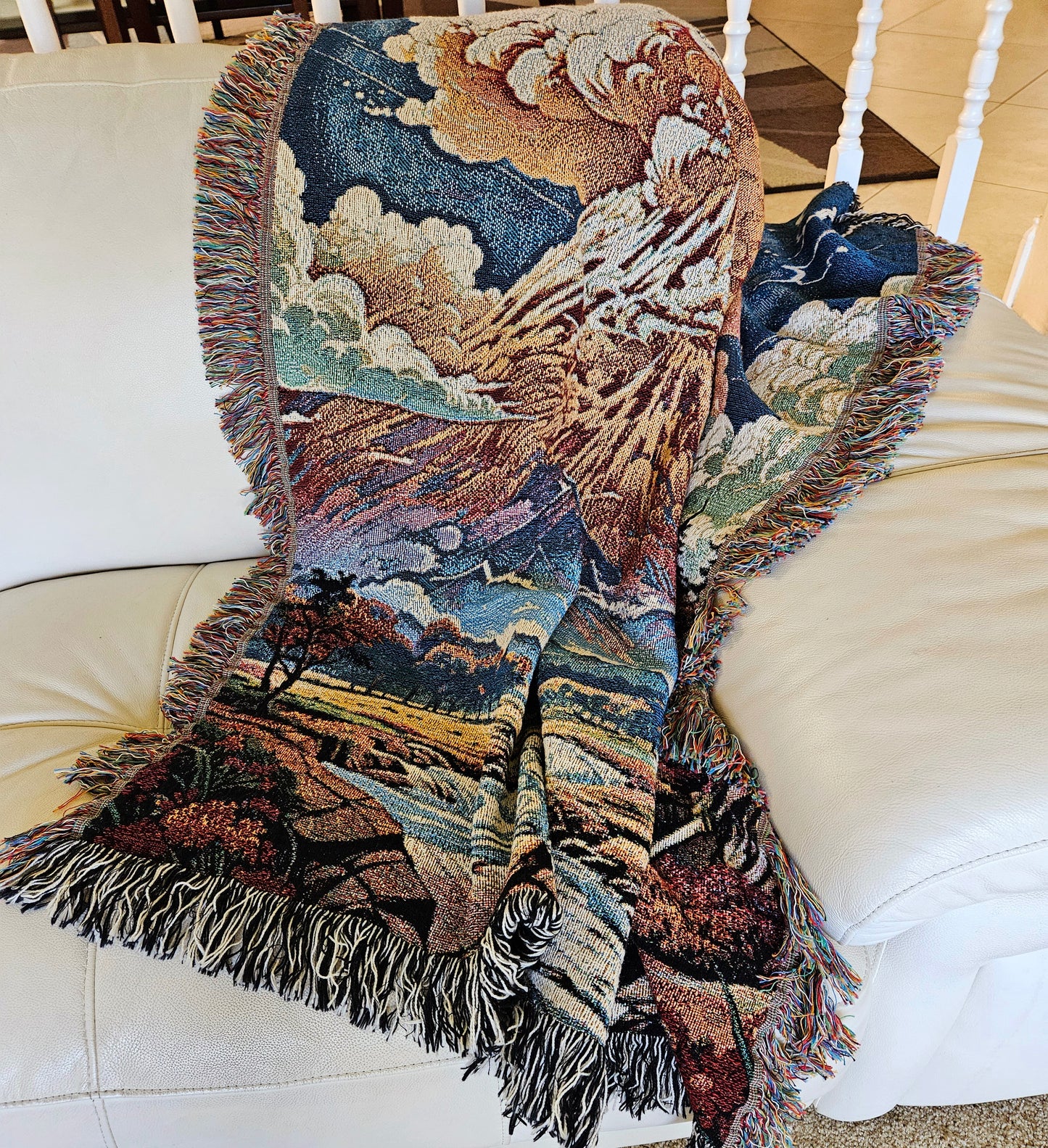 Summit Eruption Woven Blanket featuring a vibrant tapestry of a volcano, crafted from 100% cotton, perfect as a decorative throw or wall art.