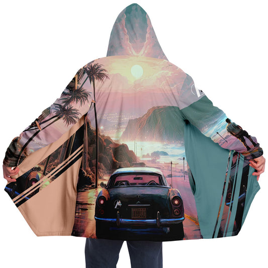 A person wears the Reflections in the Rain 1337 Cloak, featuring a car and sunset design, crafted for comfort with micro-mink and fleece.